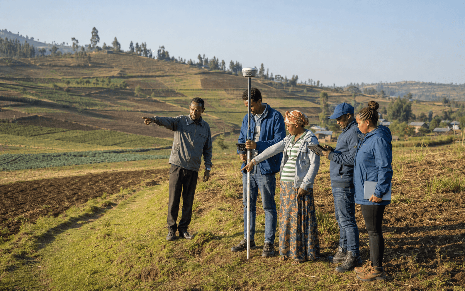 Ethiopian land administration team collecting a parcel boundary with GNSS and a tablet
